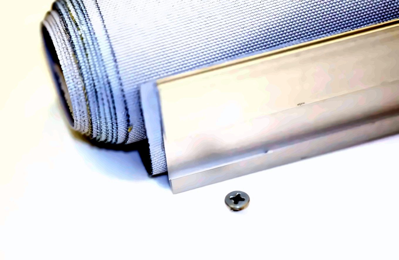 Aluminium batten profile beside a flat-head screw